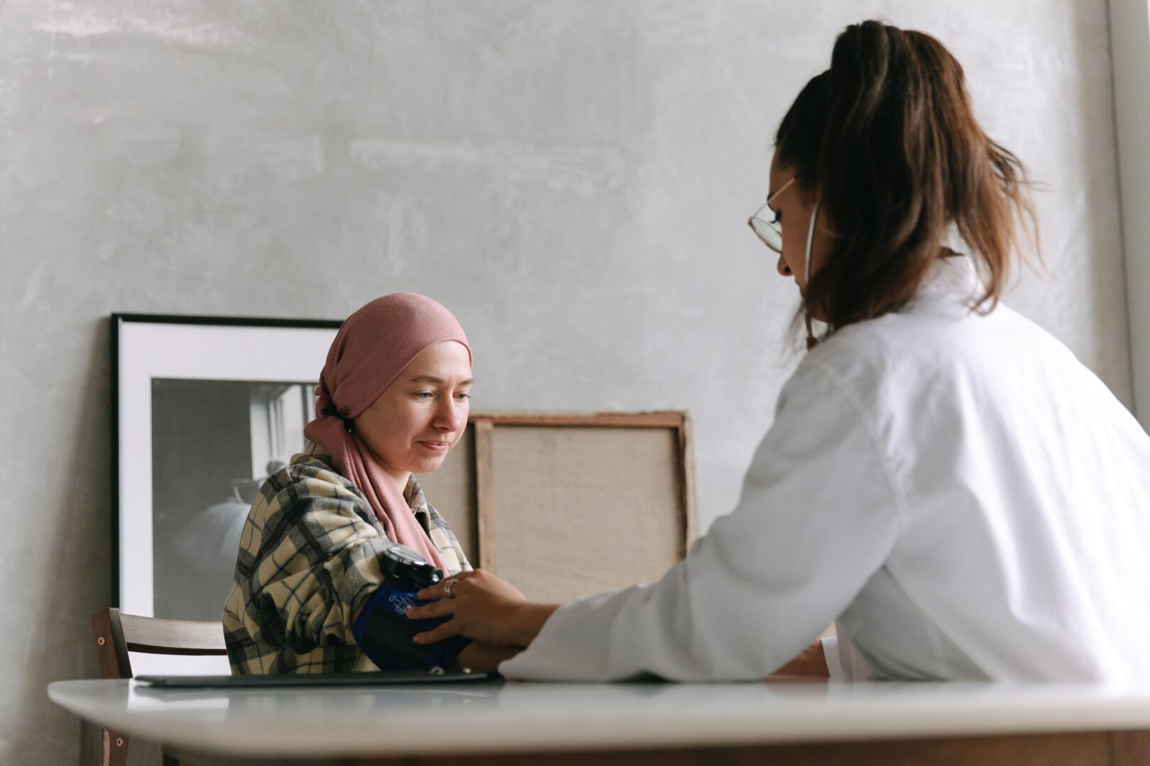 Doctor taking blood pressure of a patient